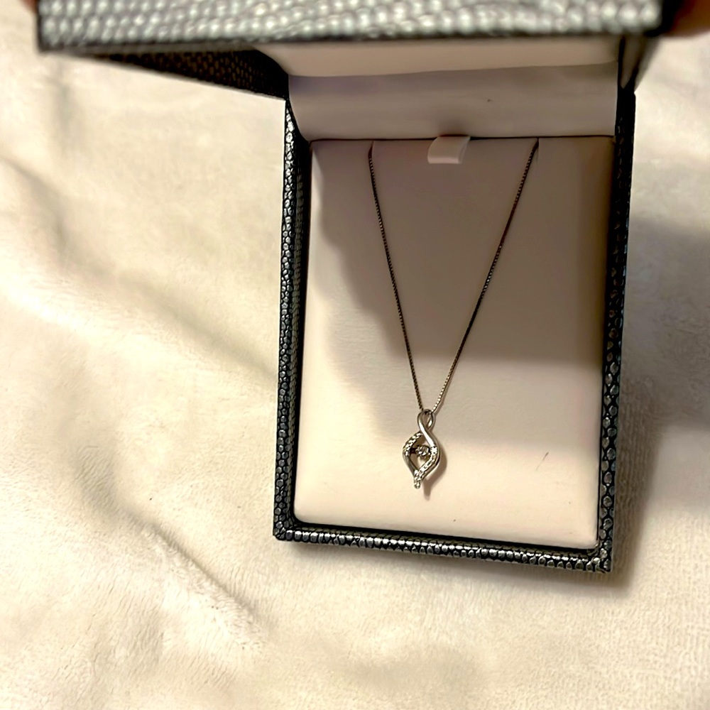 A diamond pendant necklace.